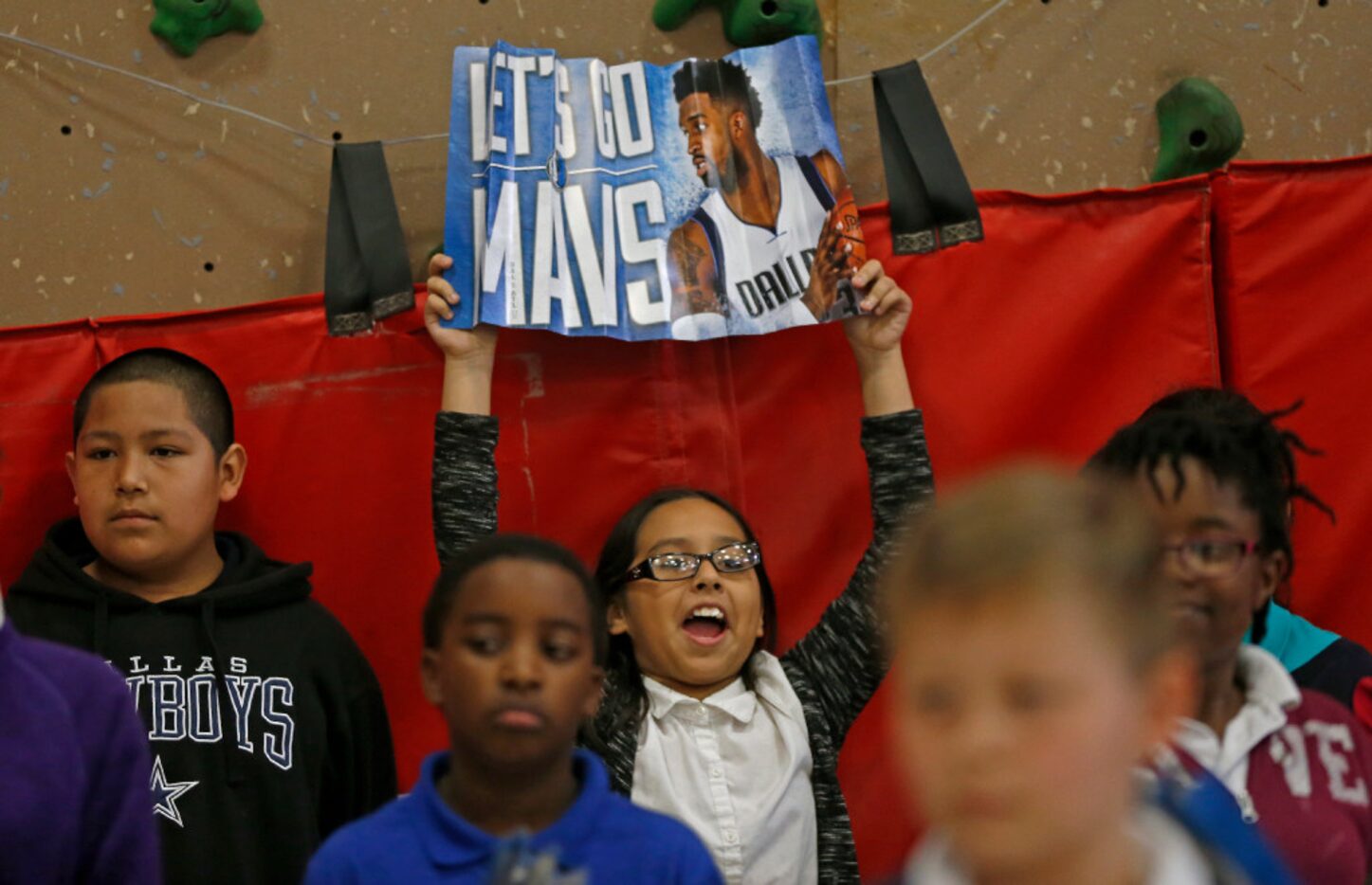 Kendra Martinez, a fifth-grader at Florence Elementary, flashed a poster of Matthews at...