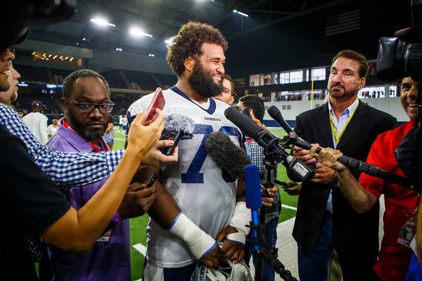 Dallas Cowboys center Joe Looney (73) speaks with the media after the team's training camp...