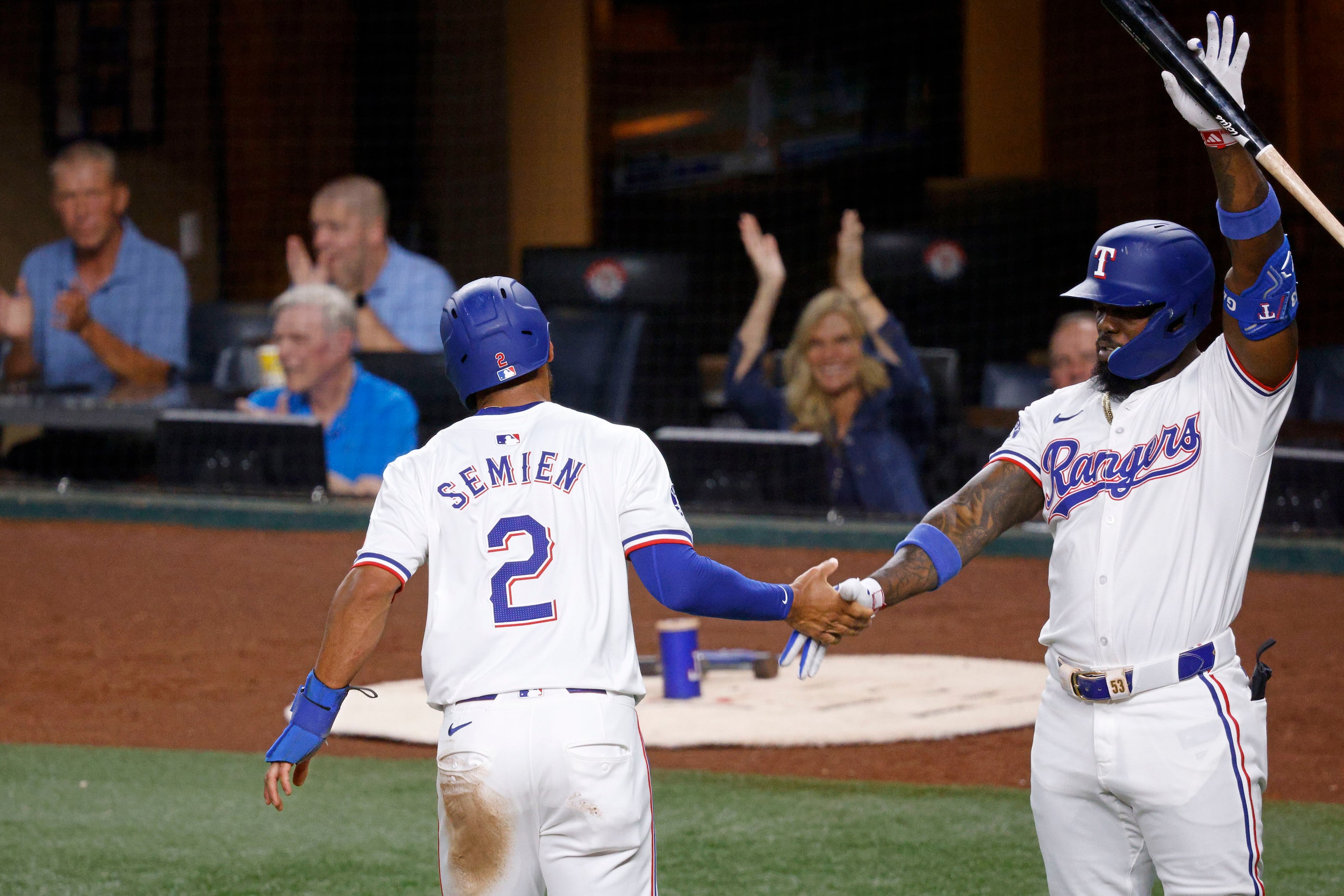 Texas Rangers second base Marcus Semien (2) gets a high-five from his teammate Texas Rangers...