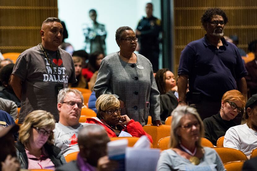 Supporters stand as Ronnie Mestas speaks to DISD trustees before they voted on several...