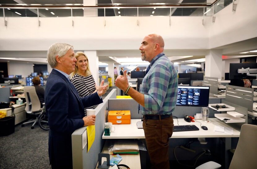 Jim Moroney (left) compliments City Hall reporter and columnist Robert Wilonsky on a story,...