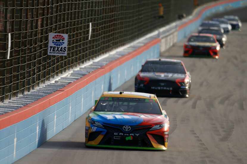 FORT WORTH, TEXAS - NOVEMBER 03: Kyle Busch, driver of the #18 M&M's Toyota, leads a pack of...