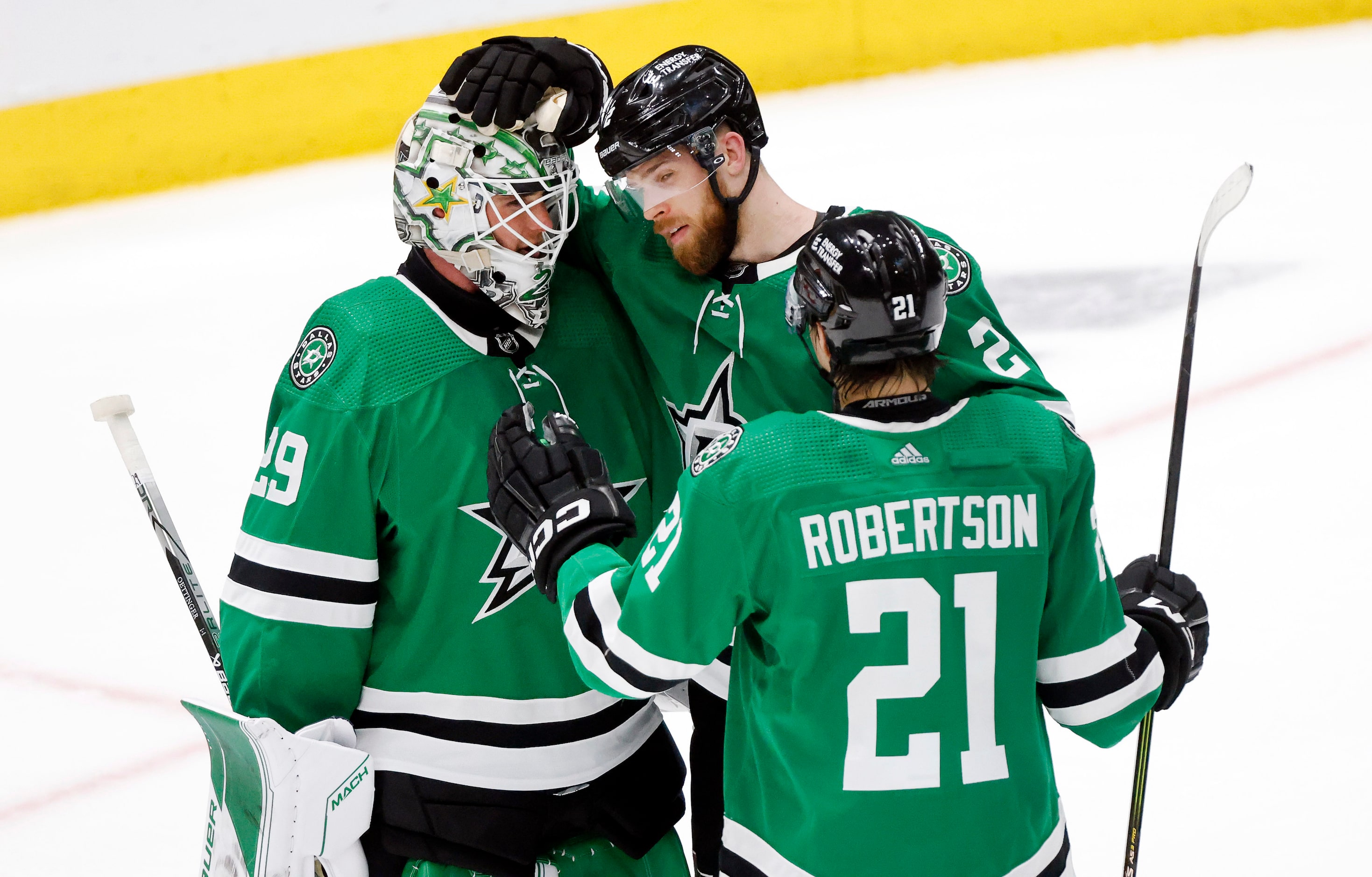 Dallas Stars defenseman Jani Hakanpää (2) and left wing Jason Robertson (21) congratulate...