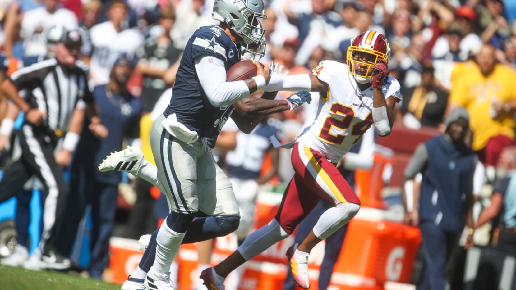 Dallas Cowboys quarterback Dak Prescott (4) carries the ball past Washington Redskins...