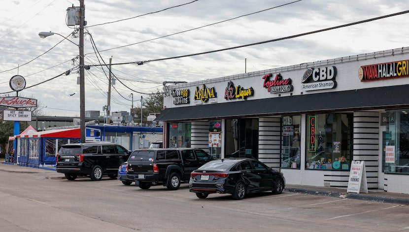 Cars sit parked in pull-in spaces along Greenville Avenue near Martel Avenue in the Lower...