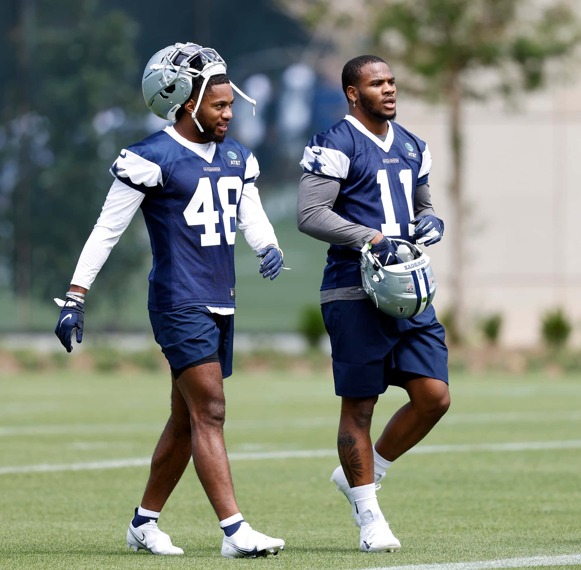 Dallas Cowboys rookie linebackers Jabril Cox (48) and Micah Parsons (11) walk off the field...
