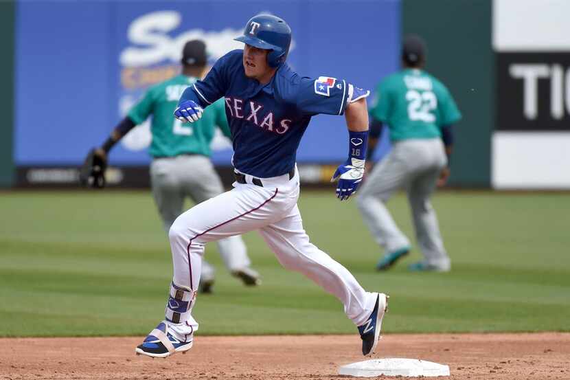 SURPRISE, AZ - MARCH 03:  Ryan Rua #16 of the Texas Rangers runs to third base in the second...