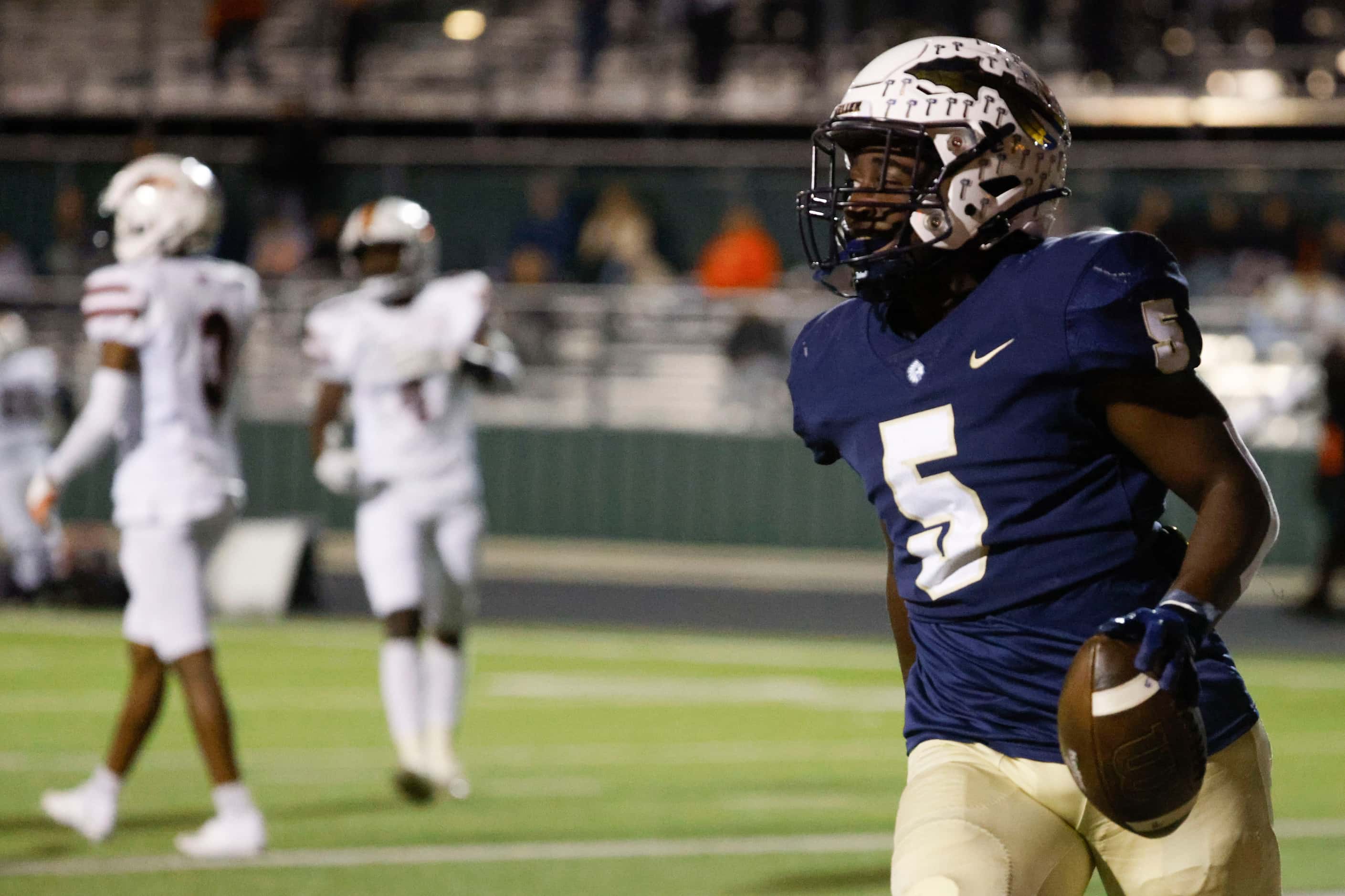 Keller High’s Cameron Rayford (5) looks towards the sideline after scoring a touchdown...