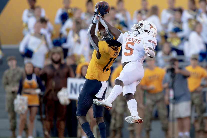 Texas defensive back D'Shawn Jamison (5) intercepts a pass intended for West Virginia wide...
