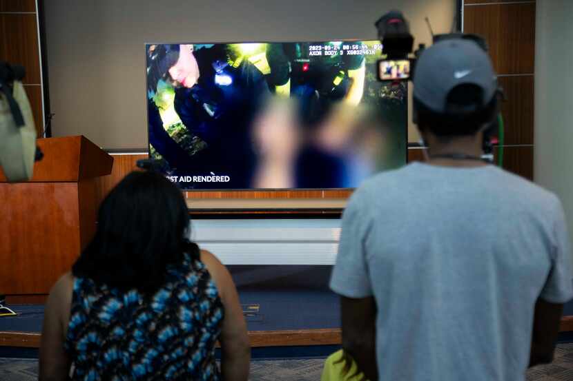 Bodycam footage is shown during a news conference about a man killed by Dallas police during...