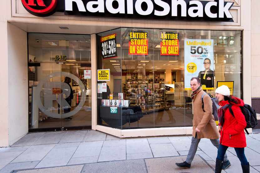 People walk past the Radio Shack in downtown Washington, DC, March 16, 2017, one of the 365...