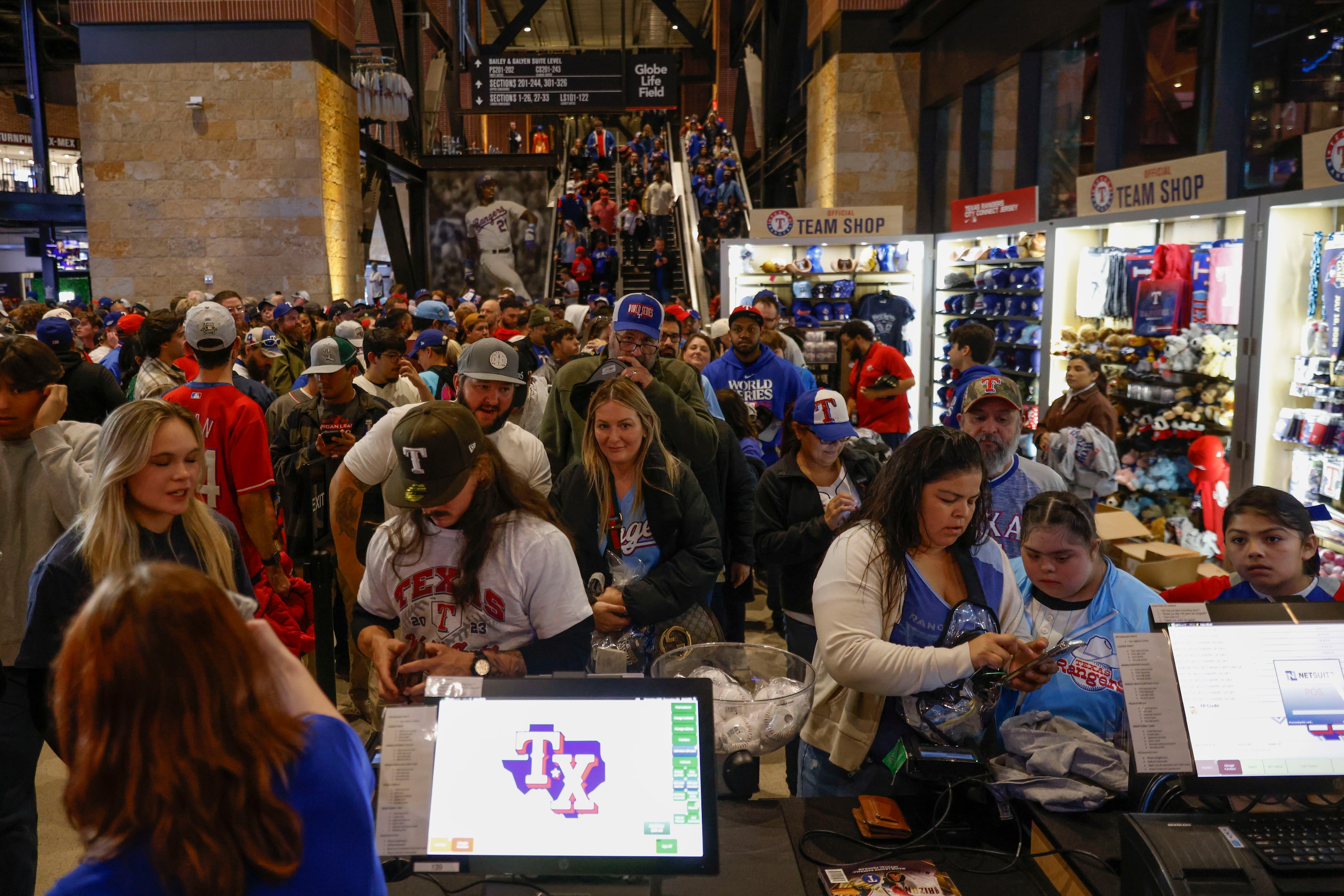 Texas Rangers fans wait in line to buy World Series merchandise following Texas Rangers’...