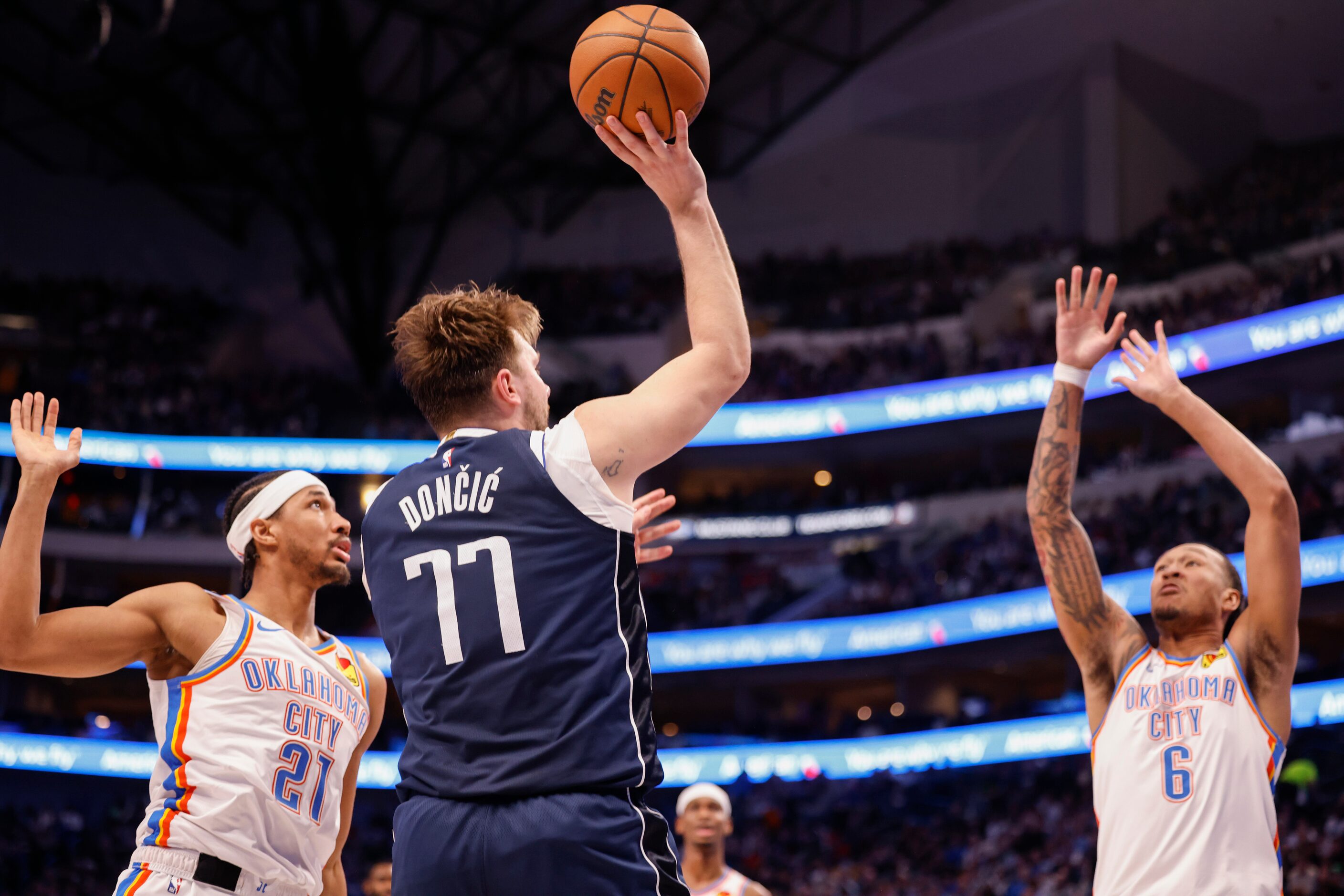 Dallas Mavericks guard Luka Dončić (77) shoots a successful three pointer over Oklahoma City...