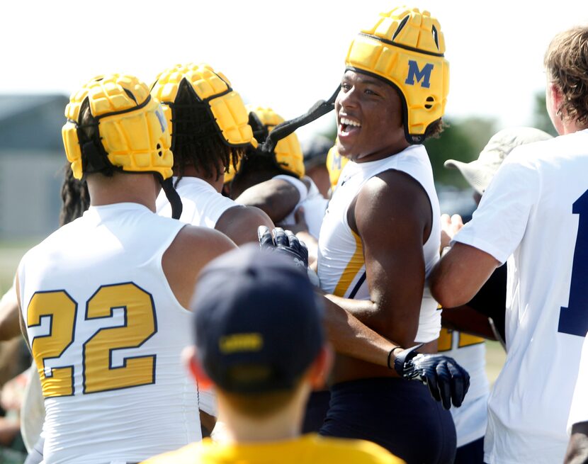 McKinney Lions players celebrate in the end zone following their come-from-behind overtime...