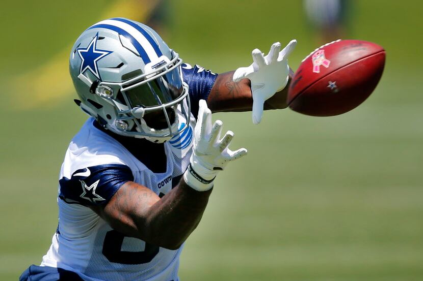 Dallas Cowboys wide receiver Dez Bryant (88) goes to a knee to catch a pass during organized...
