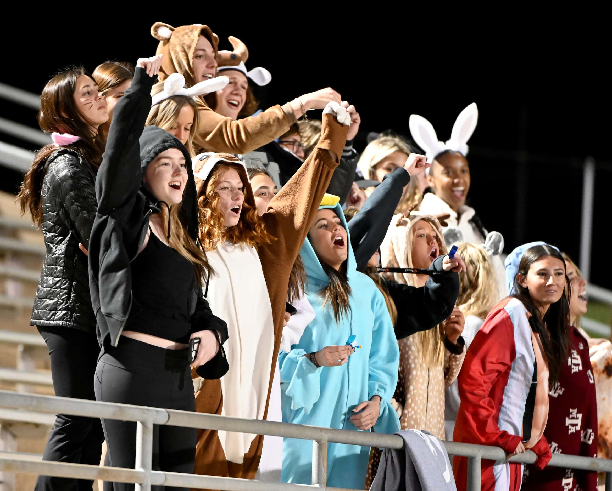 Flower Mound's students cheer in the first half of a high school football game between...