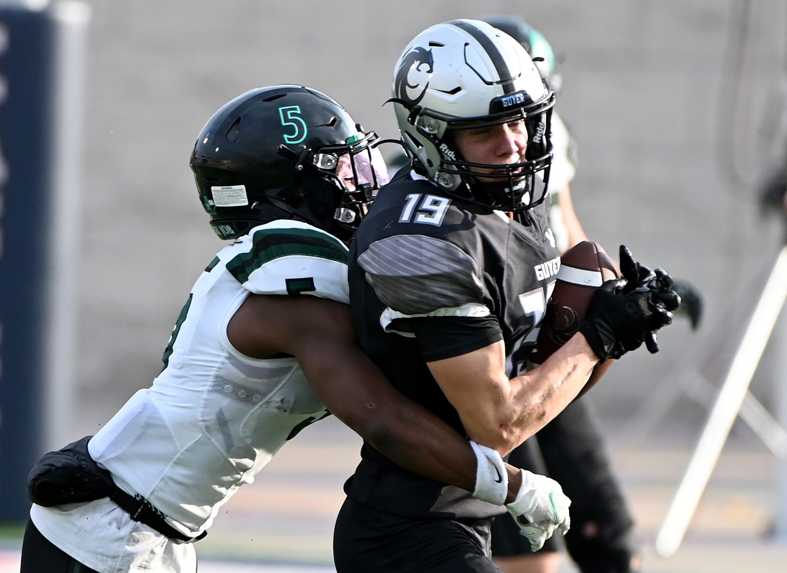 Denton Guyer's Grayson O’Bara (19) is tackled by Prosper's Steven Richardson (5) after a...