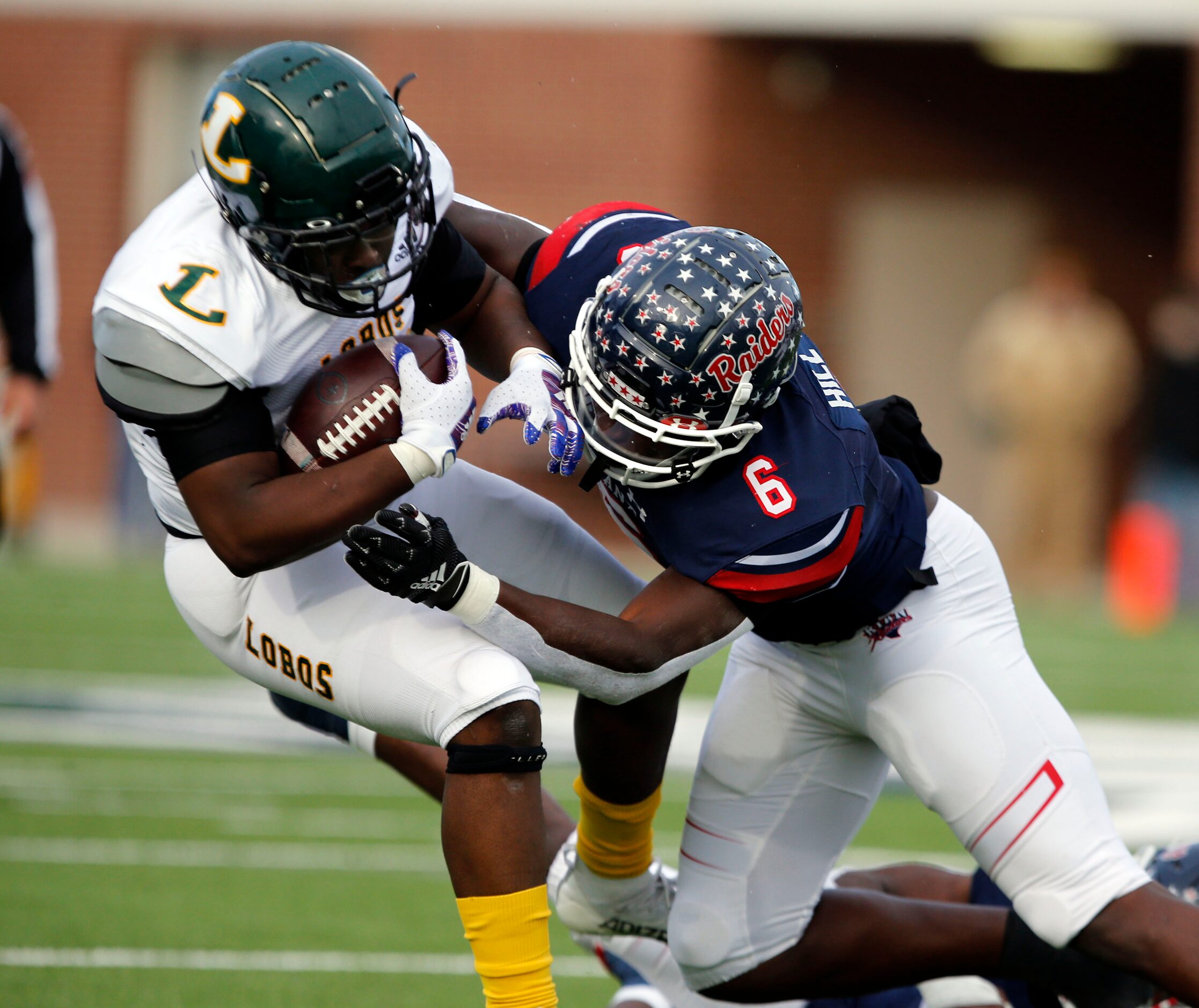 Longview RB Isaiah Harris (13) is slammed by Denton Ryan LB Anthony Hill Jr. (6) during the...