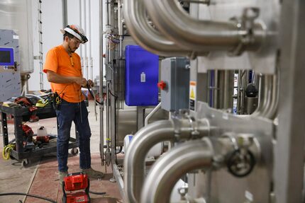 Angel Rodrigue works on a processor that sanitizes products at SunOpta’s manufacturing plant...