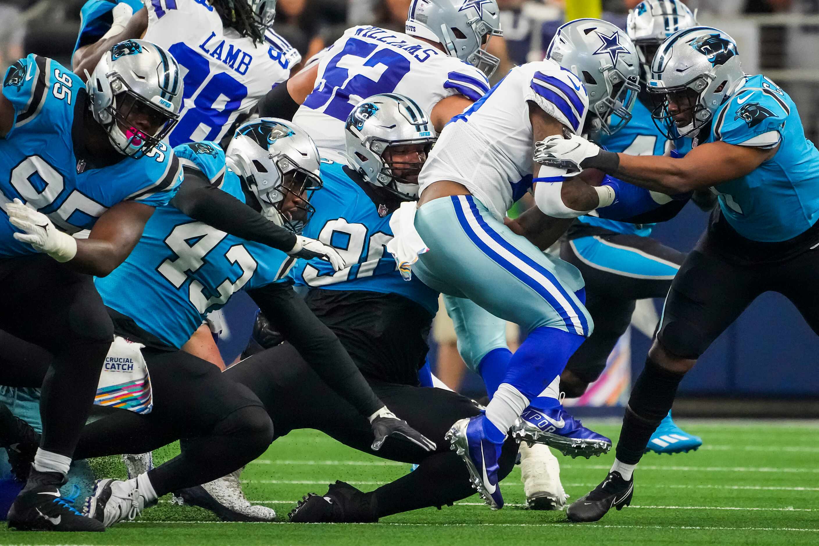 Dallas Cowboys quarterback Dak Prescott (4) is brought down by Carolina Panthers defensive...