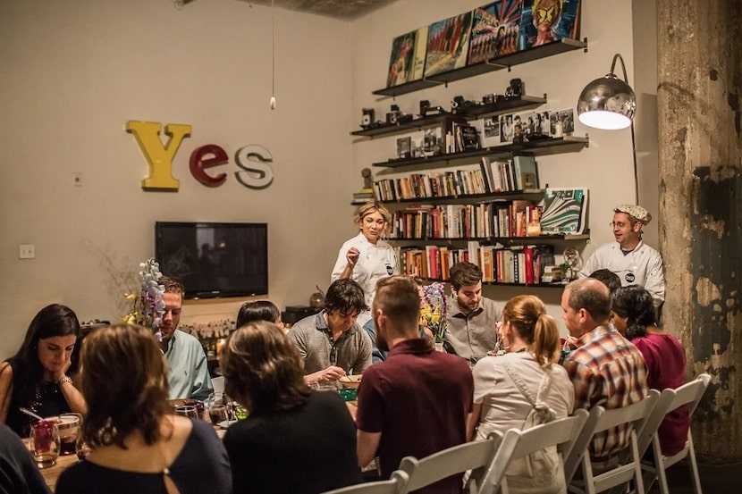 Chef Jennie Kelley (left) and chef Ben Starr (right) explain a dish to diners at a Frank...