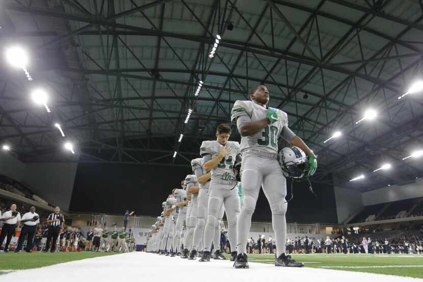 Reedy's Justin Gipson (30) and team during the playing of the National Anthem before playing...