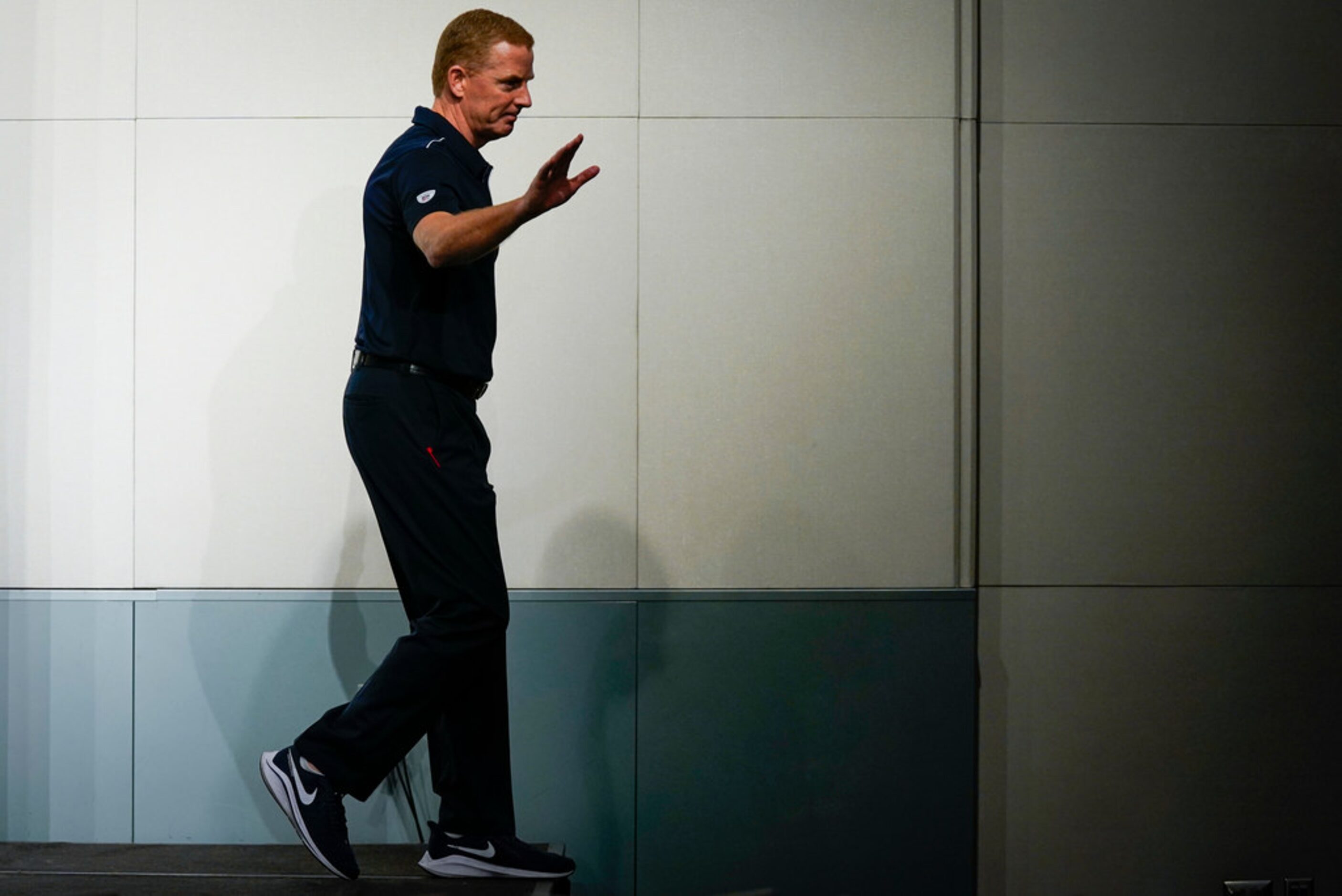 Dallas Cowboys head coach Jason Garrett walks off the stage after addressing the media after...