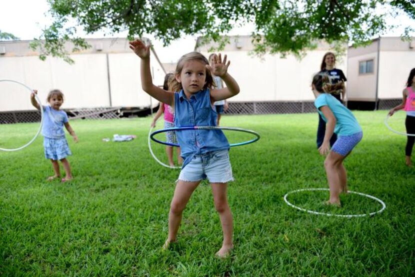 
Evelina Kalenik, 5, Hula Hoops during summer camp at River of Life, an Evangelical...