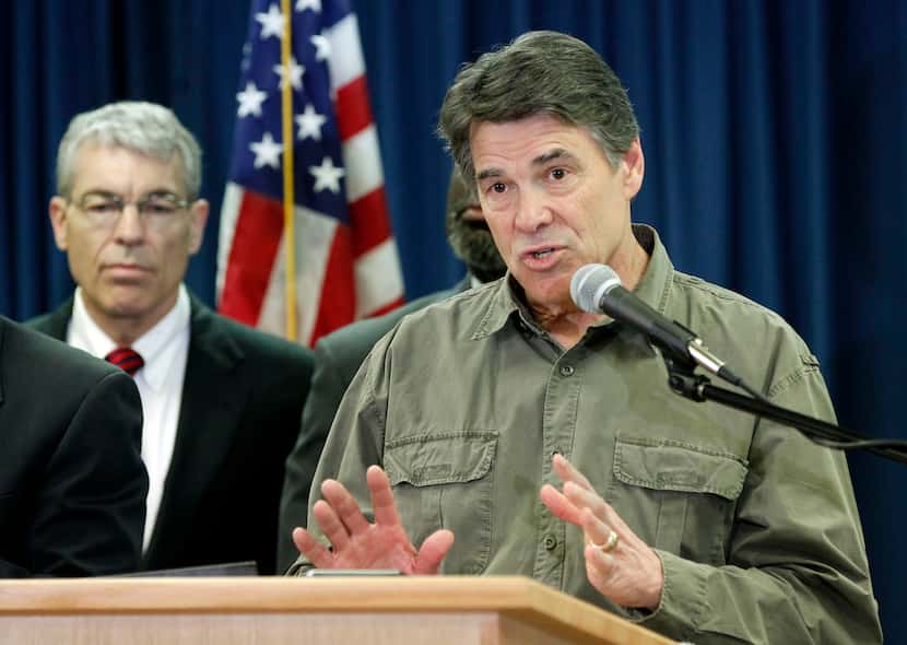 Texas Gov. Rick Perry answers questions from the media during a press conference at Texas...