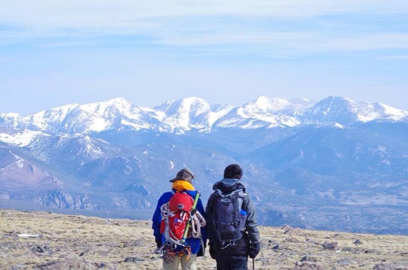 
Hayden Wilson (left) and his friend, Ryan Gong, look out from Longs Peak in Colorado onto...