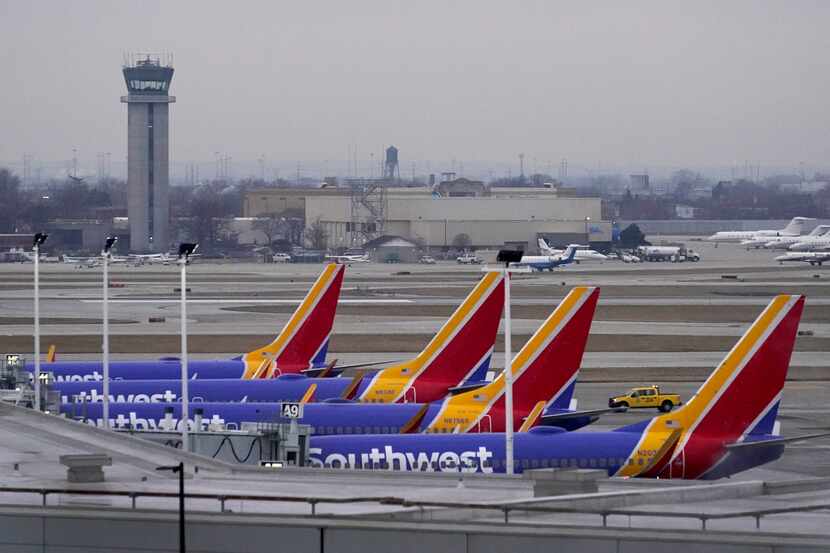 Four Southwest Airlines passenger jets sit at their gates at Chicago's Midway Airport as...