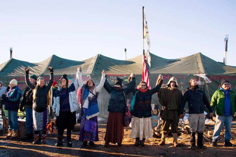 Activists celebrate at Oceti Sakowin Camp on the edge of the Standing Rock Sioux Reservation...