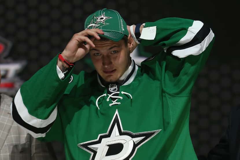 NEWARK, NJ - JUNE 30:  Valeri Nichushkin puts on his hat and jersey after being selected...