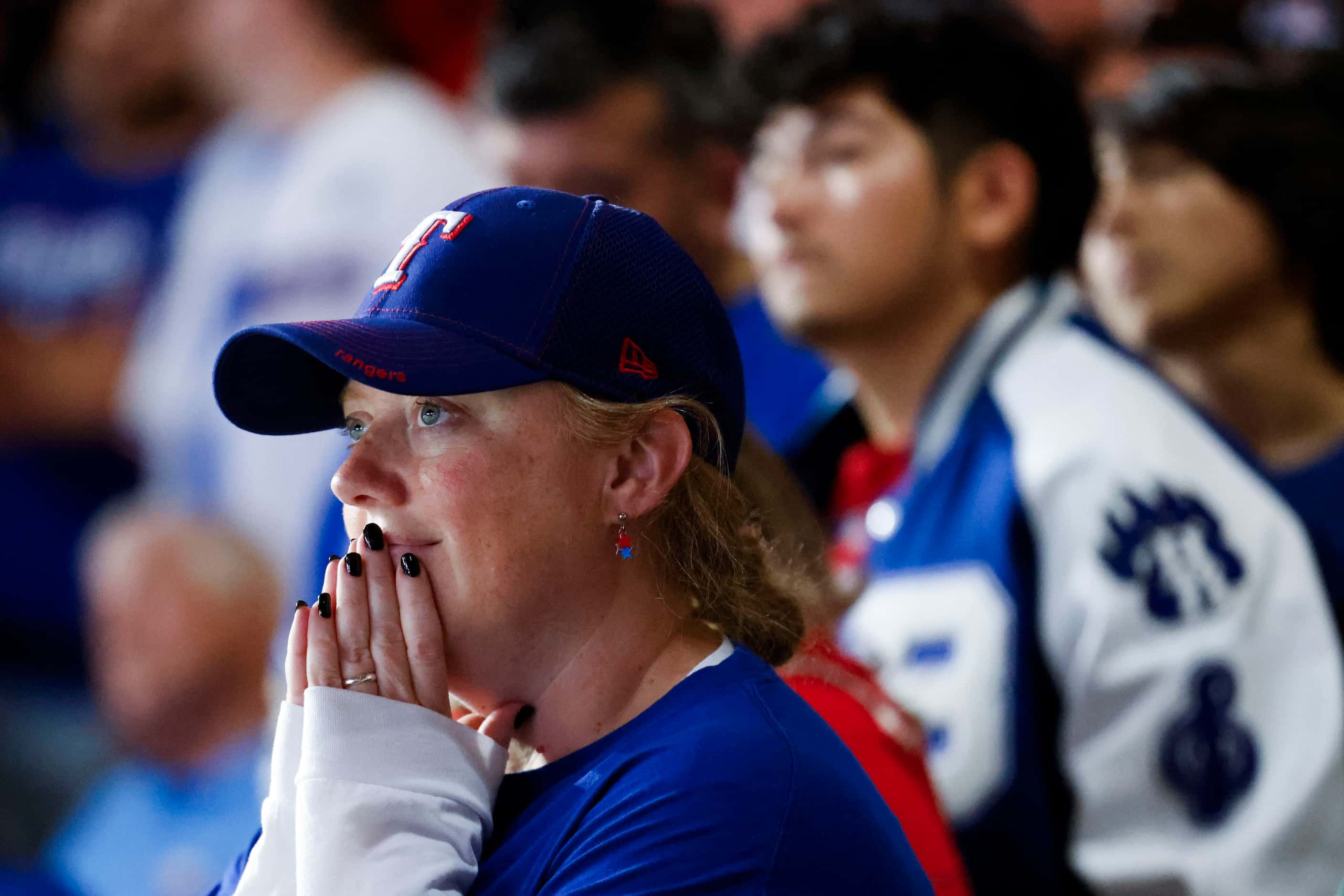 A Texas Rangers fan watches the big screen following Texas Rangers’ winning the World Series...