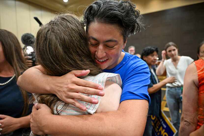 Iman Alsaden, chief medical officer for Planned Parenthood Great Plains, hugs Rachel Sweet,...