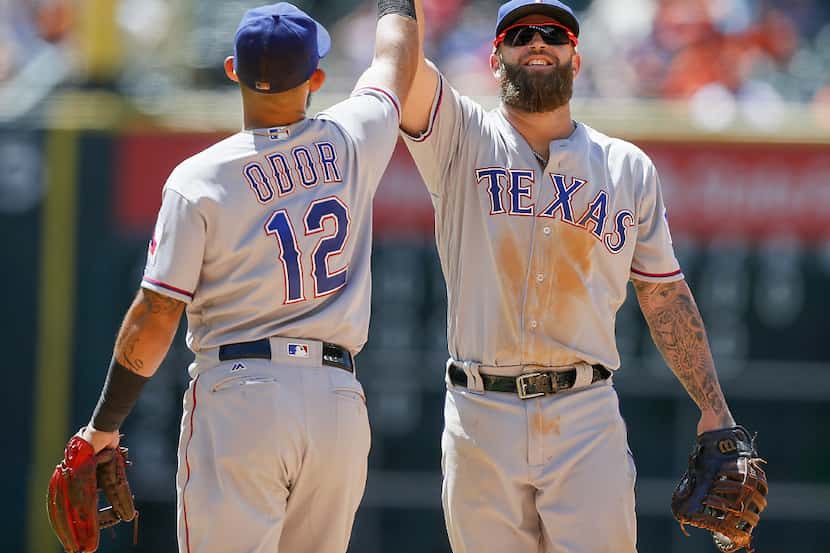 HOUSTON, TX - MAY 04: Rougned Odor #12 of the Texas Rangers and Mike Napoli #5 high five...