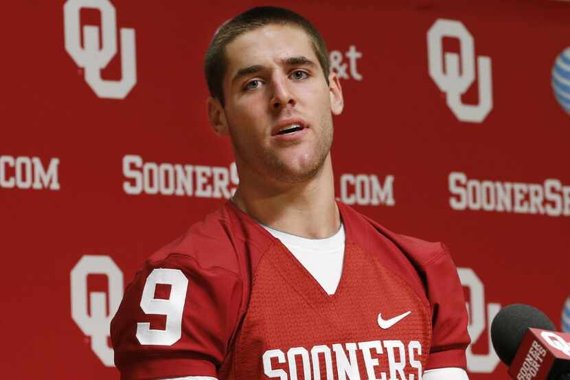 Oklahoma quarterback Trevor Knight answers a question during a news conference in Norman,...