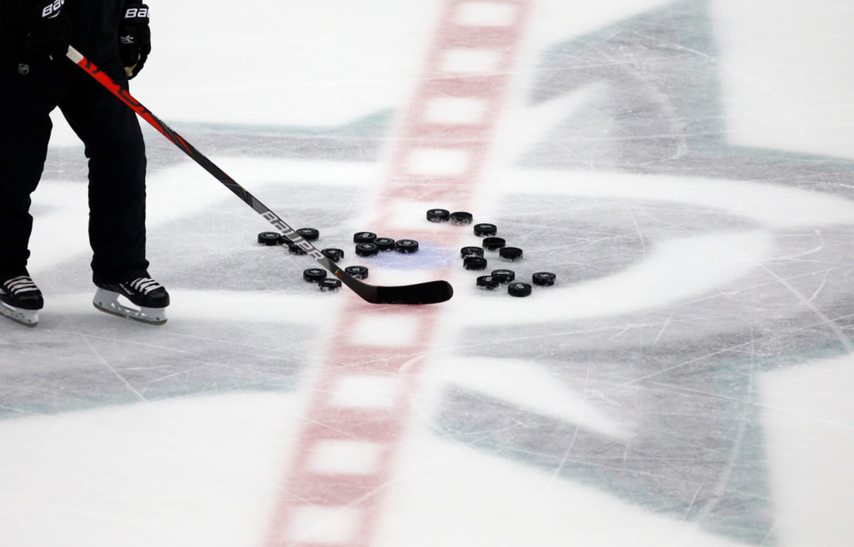 Dallas Stars pucks sit idle at center ice during Dallas Stars training camp at Comerica...