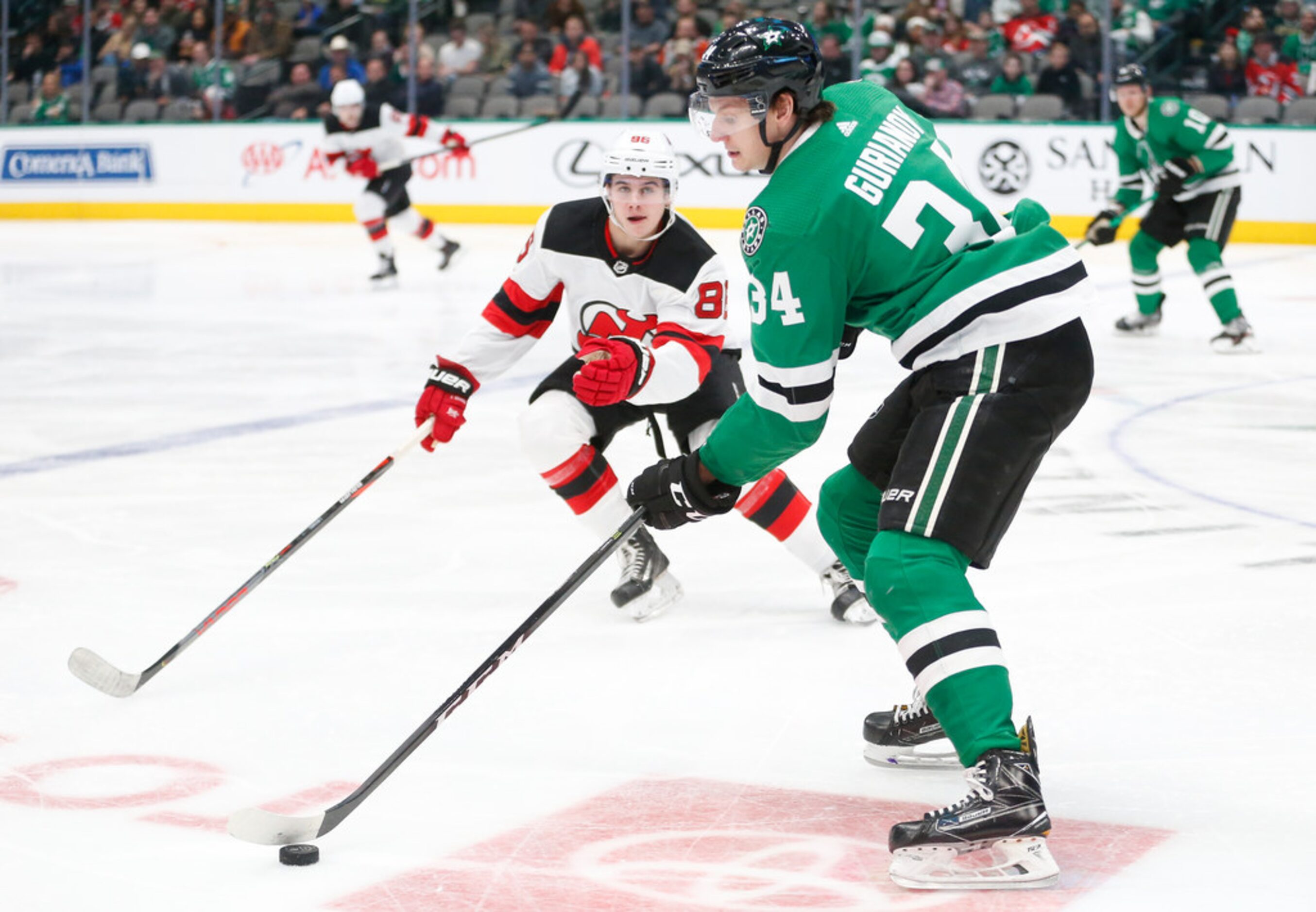 Dallas Stars right wing Denis Gurianov (34) looks to make a pass around New Jersey Devils...