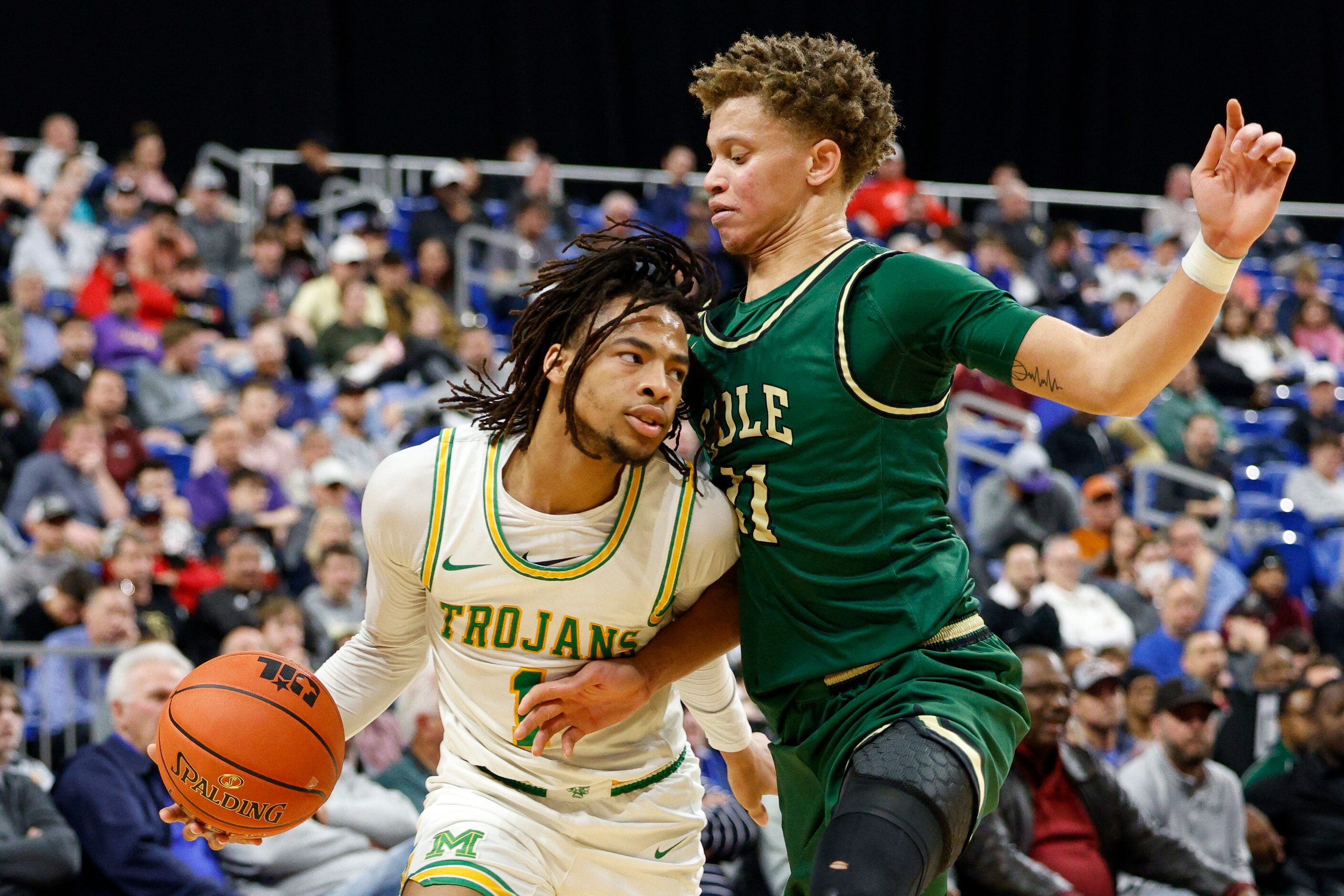 San Antonio Cole guard Trey Blackmore (11) defends against a driving Madison guard Pierre...