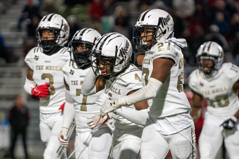 South Oak Cliff defenders celebrate senior defensive back David Spruiells’ (4) interception...