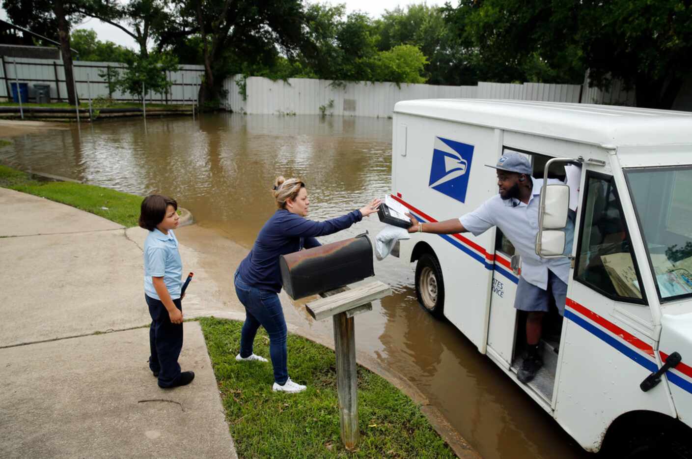 On Thursday, U.S. Postal Service carrier Terry LeRoy handed Violet Saldua and her son Jake...