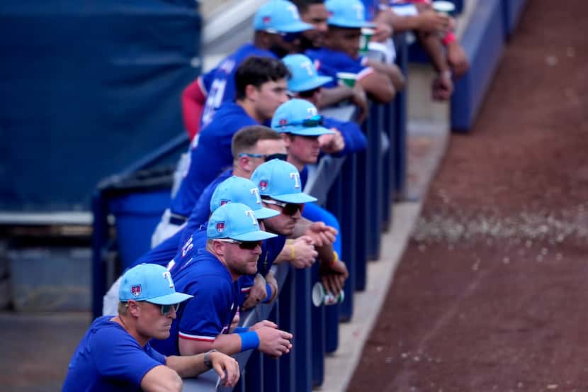 The Texas Rangers watch during the fourth inning of a spring training baseball game against...