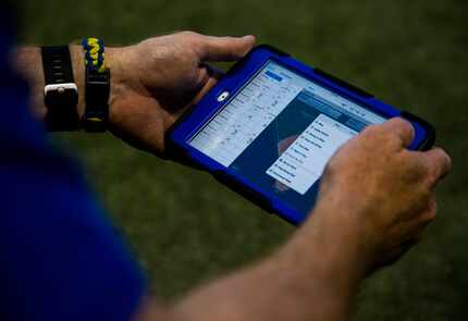 Frisco assistant coach Jeff Cantrell uses GameChanger, an live box score iPad app, to keep...