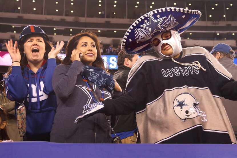 Cowboys fan Rene Sigala of Dallas (right) can only shrug as time runs out on the Cowboys in...