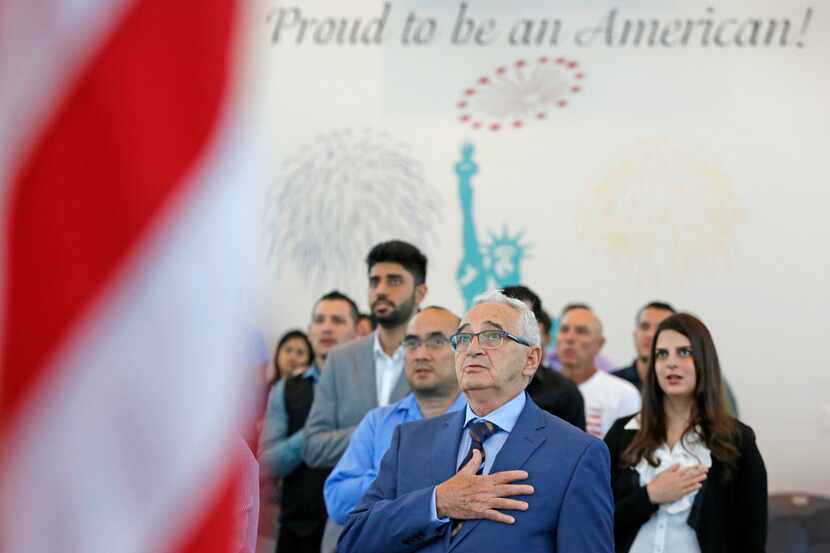 Jorge Lloveras of Cuba recited the pledge of allegiance during a naturalization ceremony...