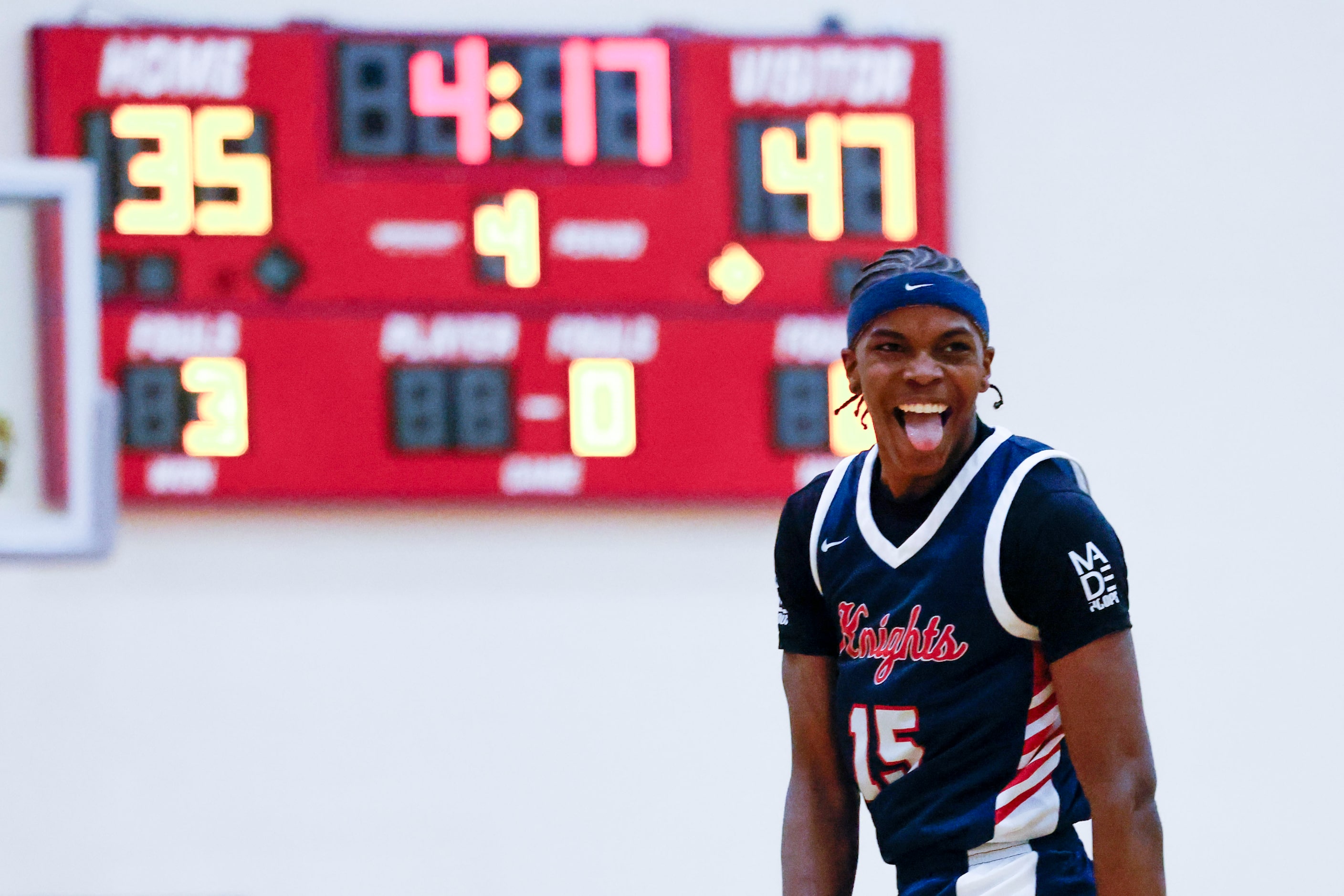 Kimball High’s Lance Carr celebrates following a dunk against Centennial High of California...