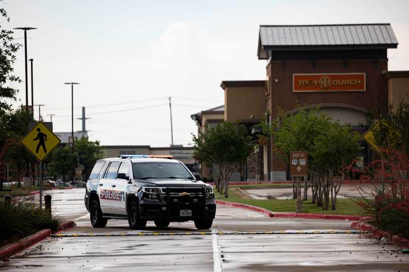 Allen police and barricades block the south entrance to Allen Premium Outlets in Allen on...