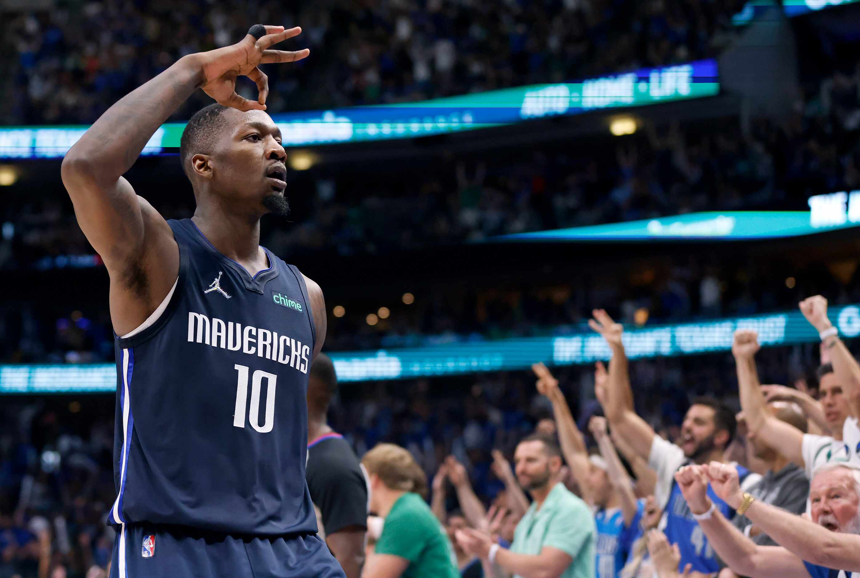 Dallas Mavericks forward Dorian Finney-Smith (10) reacts to cheering fans after a second...