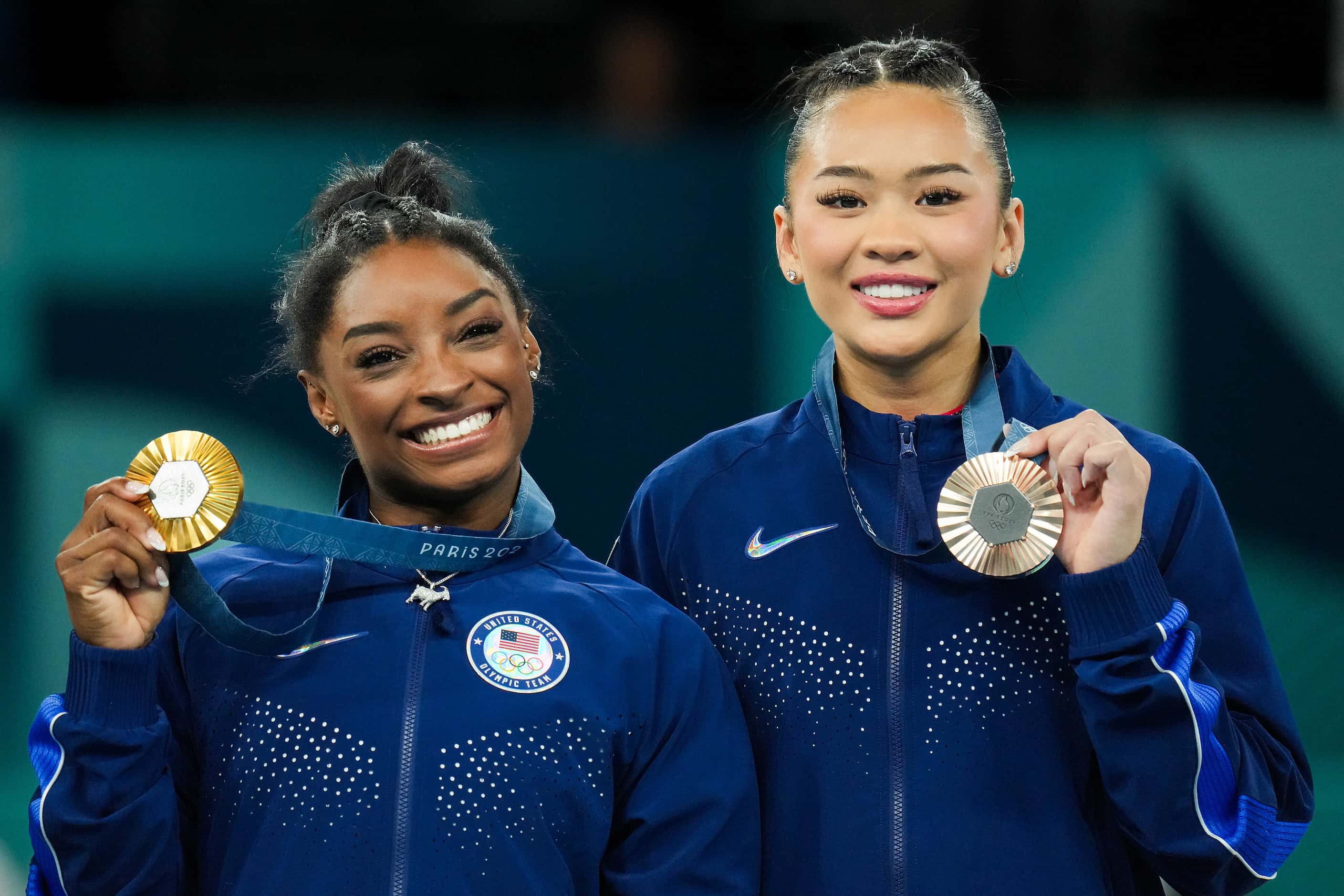 Gold medalist Simone Biles (left) and bronze medalist Suni Lee of the United States pose...
